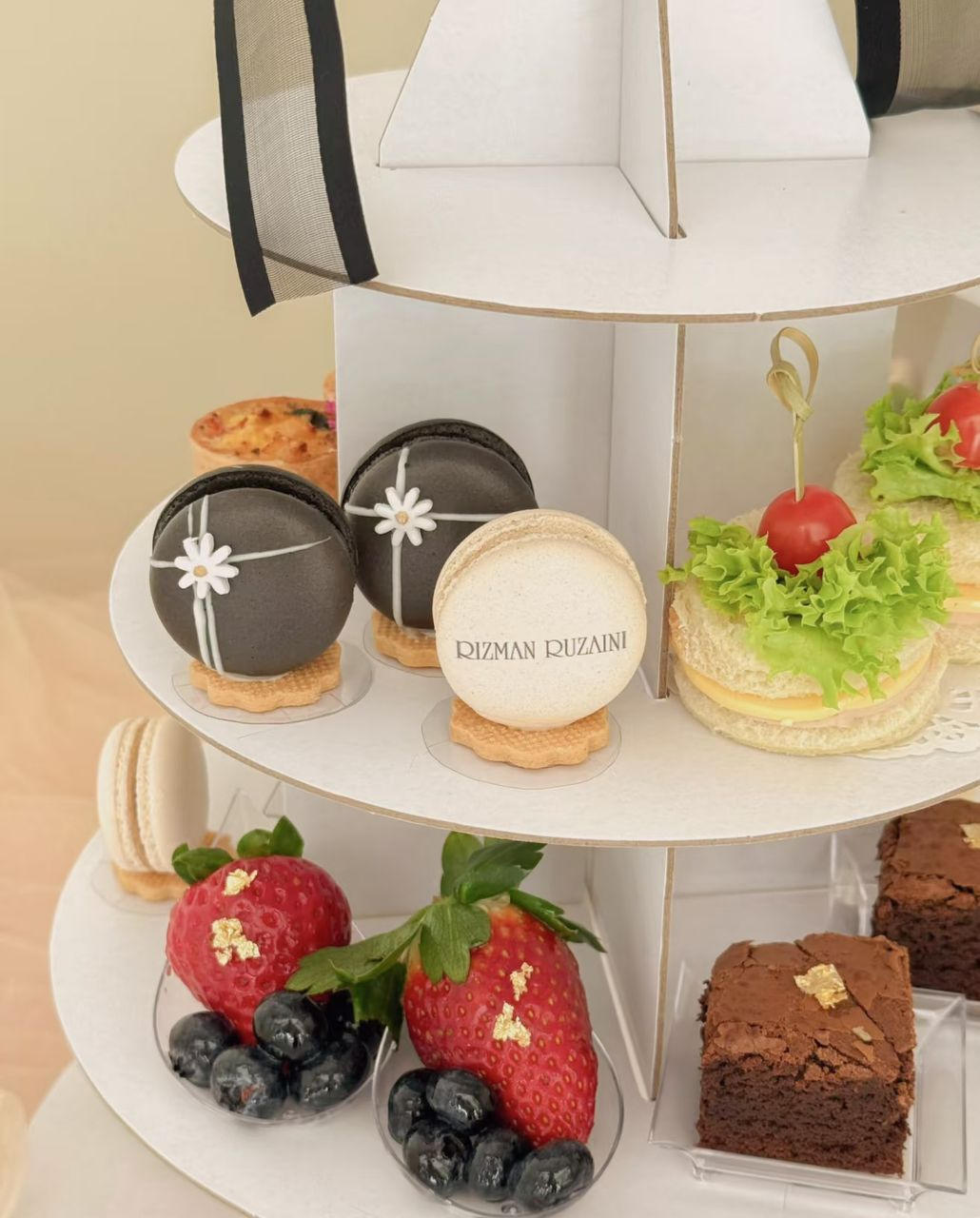 Bread9’s tiered high-tea stand with macarons, sandwiches, fruit and brownies